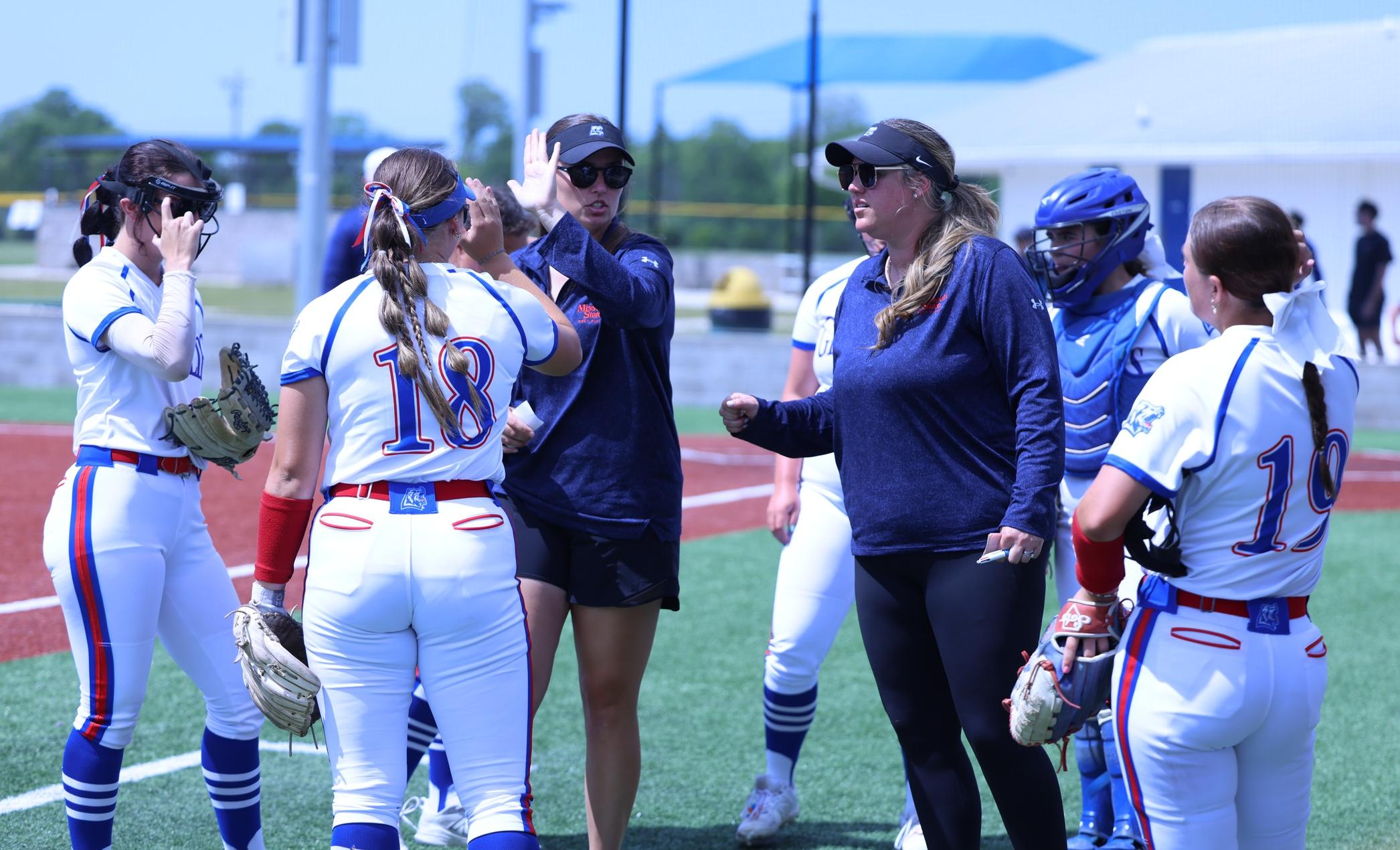 Coach Brooks talking with softball players